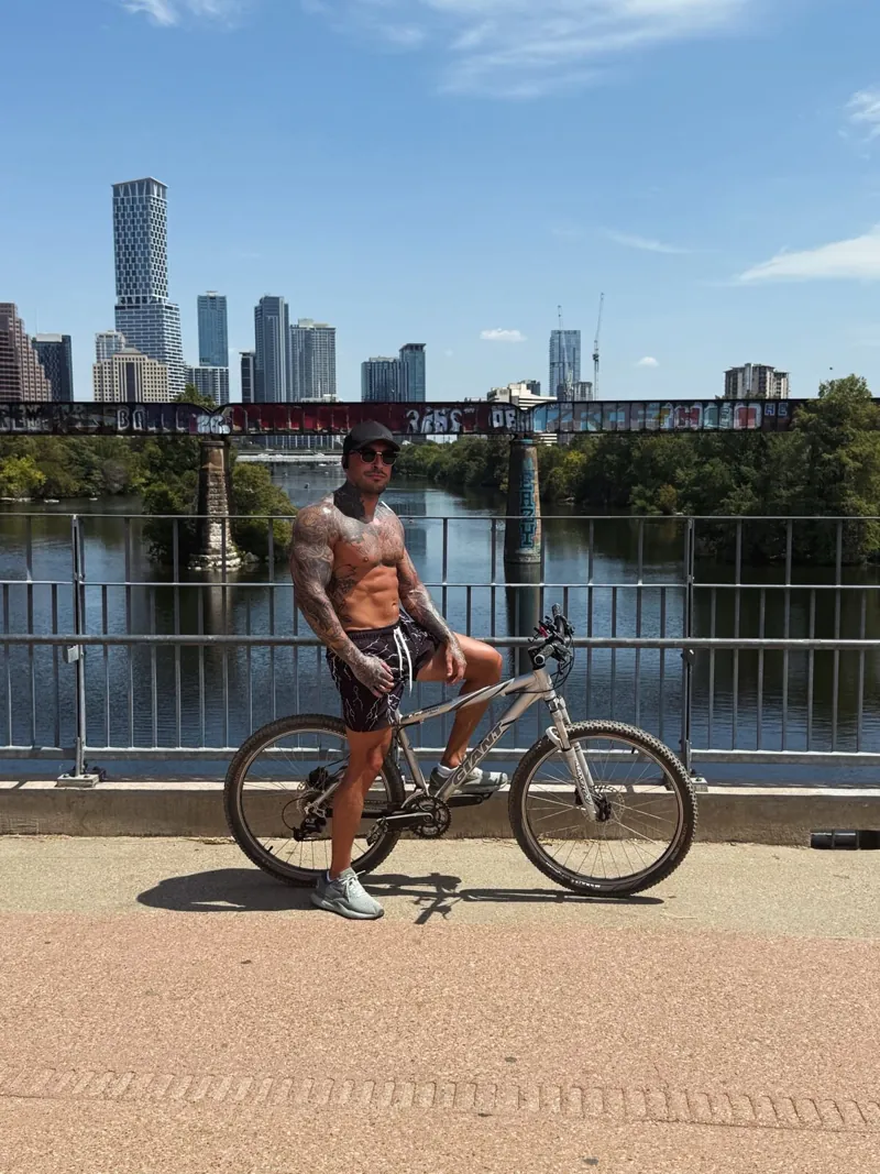 Eddy riding his bike along the river, part of his daily fitness habit